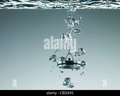 Plug bubbling in water Stock Photo