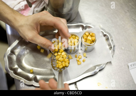 Chef preparing sauteed potato dish Stock Photo