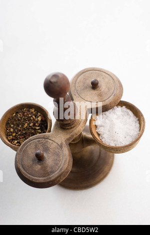 Salt cellar filled with coarse salt and crushed peppercorns Stock Photo