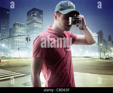 Man taking pictures in city center Stock Photo