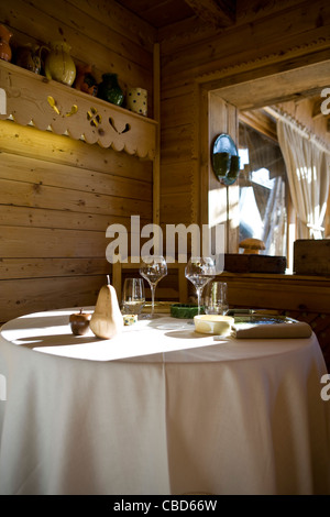 Place settings and glasses on dining table Stock Photo