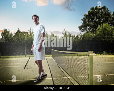 Man standing on tennis court Stock Photo