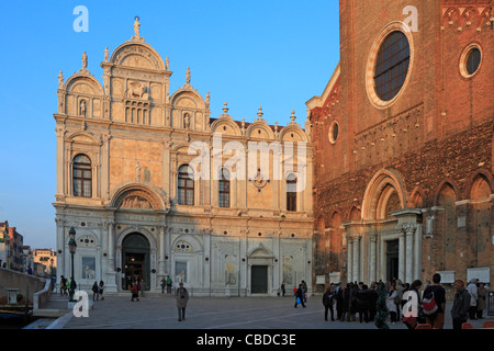 Tourists outside Scuola Grande di San Marco and Santi Giovanni e Paolo or San Zanipolo in Venice, Italy, Europe. Stock Photo