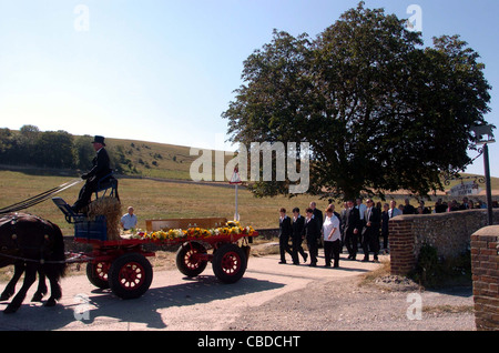 The coffin of Ronnie Sayers leaves Bulstrode Farm in Ovingdean today on a horse drawn cart followed by hundreds of villagers Stock Photo