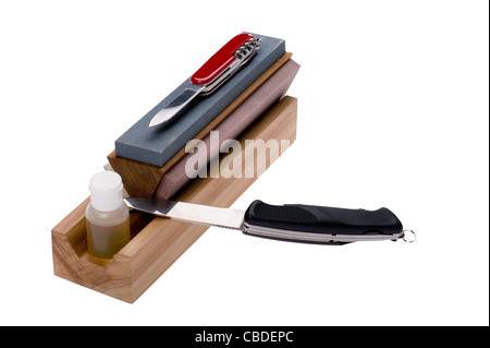 object on white - Sharpener stone and knife Stock Photo