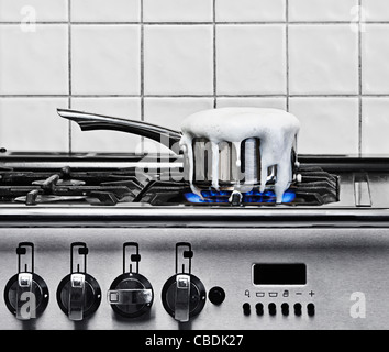Pan Boiling Over on Gas Hob Stock Photo