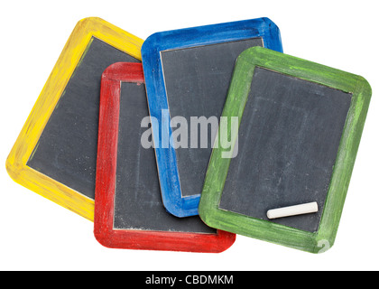 four blank vintage slate blackboards in colorful wood frames with chalk, isolated on white Stock Photo