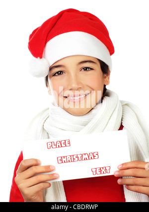 Happy Santa boy smiling, portrait of a cute teen holding blank card isolated on white backgroung, kid wearing red Christmas hat Stock Photo