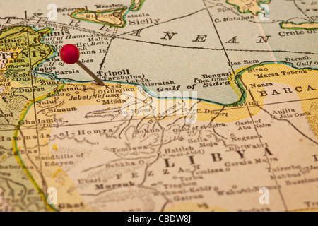 Libya and Tripoli on vintage 1920s map with a red pushpin, selective focus (printed in 1926 - copyrights expired) Stock Photo
