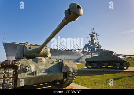 Tanks in foreground of Battleship USS Alabama Memorial park tourist attraction in Mobile Alabama Stock Photo