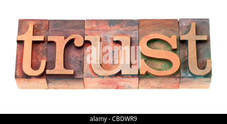 trust word in vintage wooden letterpress printing blocks, stained by color inks, isolated on white Stock Photo