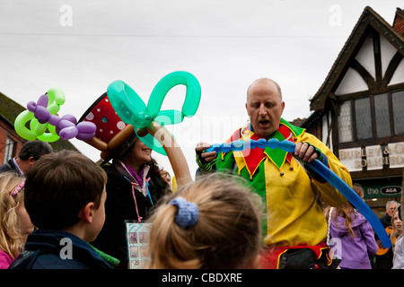 Couple making balloon animals for children at the annual Christmas Fair in Haslemere, Surrey Stock Photo