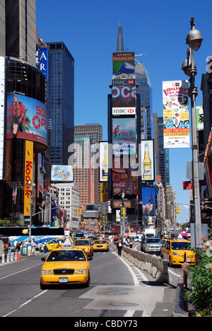 Times Square with the city's well known yellow cabs on a sunny day. Times Square is, a very popular tourist attraction. Stock Photo