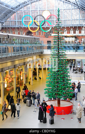 St Pancras interior of train station indoor Christmas tree formed in Lego bricks in retail shopping area Olympic rings above Camden London England UK