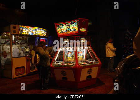 people playing on slot machines in coral island Promenade, Blackpool, Lancashire, FY1 5DW, England, UK Stock Photo