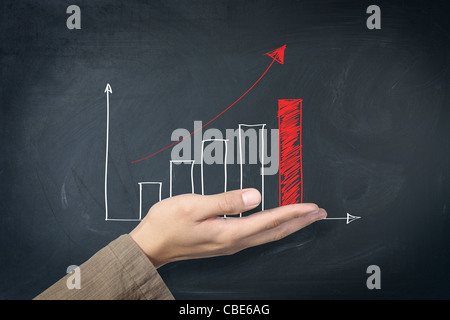 red arrow graph on hand Stock Photo