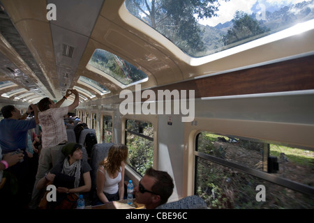 Tourists taking picture from inside the train on his way to Aguas caliente, Peru Stock Photo