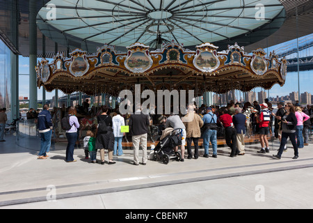 People visit historic Jane's Carousel in Brooklyn Bridge Park in the DUMBO section of Brooklyn in New York City. Stock Photo