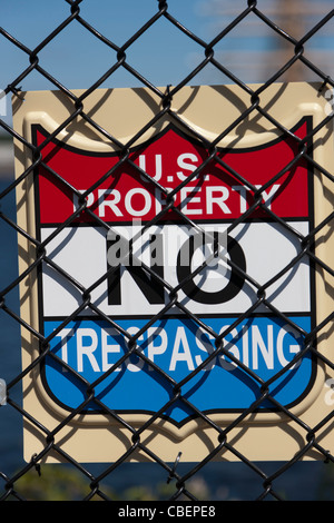 A 'No Trespassing' sign on a fence surrounding a US military facility. Stock Photo