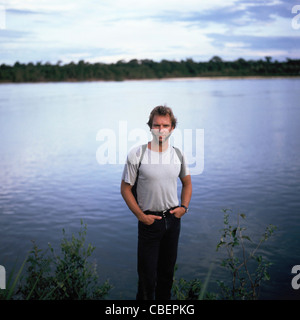 Xingu River, Brazil. Sting with intricate face paint standing on the shores of the Xingu River. Stock Photo