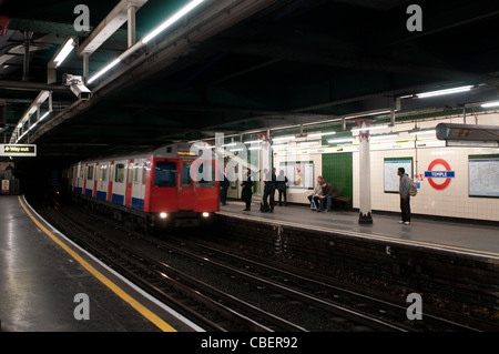 A District Line Train Arriving at Temple Underground Station, London, England, UK Stock Photo