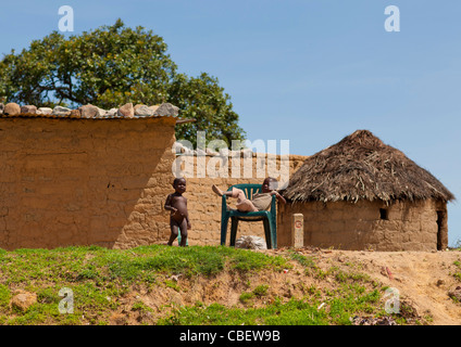 Kids Playing In Front Of Huts In Lubango, Angola Stock Photo