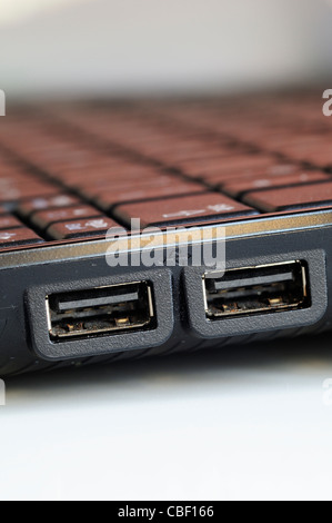 Closeup of two USB ports on the side of a black laptop Stock Photo