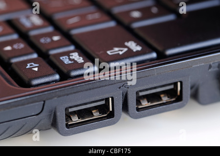 Closeup of two USB ports on the side of a black laptop Stock Photo