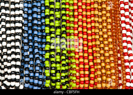 Different colored glass beads hanging in a row Stock Photo