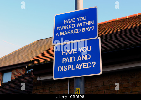 'Have you paid and displayed' and' Have you parked within a marked bay' signs in car park Stock Photo