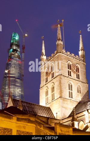 Southwark Cathedral and The Shard London Bridge skyscraper near completion stage at night South Bank London England UK Stock Photo