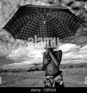 Mwila Girl With An Umbrella, Chibia Area, Angola Stock Photo