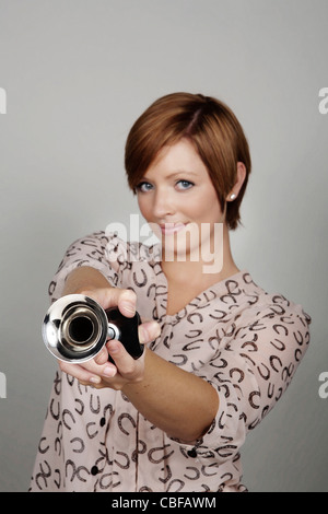 woman with a bike horn making a noise Stock Photo