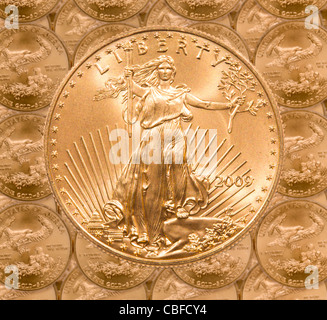 Gold Eagle one ounce coins in a patterns and stacked on each row with a single Liberty coin on the top