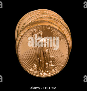 Gold Eagle one ounce coins in a stack and isolated against black