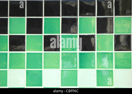Old ceramic tile in green, black and white Stock Photo