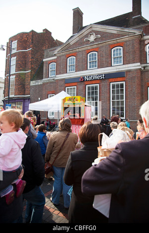 Louth Victorian Market,  Lincolnshire, England traditional punch and judy show puppets watched by crowd Stock Photo