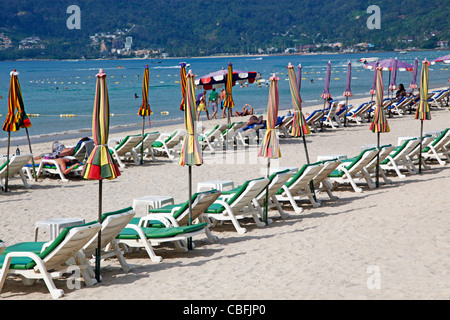 Holiday beach scene with sun loungers and umbrellas on sandy Patong Beach, Patong, Phuket, Thailand Stock Photo