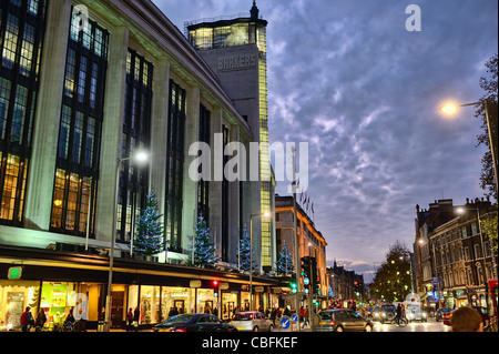 Barker Building, Kensington High Street, London, England, UK Europe, lit up at dusk Stock Photo