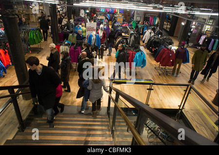 Customers shop in the new REI outdoors store located in the historic Puck Building in the Soho neighborhood of New York Stock Photo