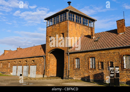 The reception building at Auschwitz-Berkenhau II concentration camp with watchtower and archway through which trains brought prisoners. Stock Photo
