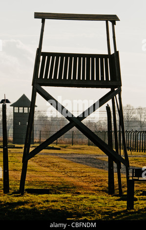 Watchtowers beside electrified barbed wire security fence at Auschwitz Berkenau Nazi concentration camp Stock Photo