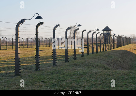 Watchtower beside electrified barbed wire security fence at Auschwitz Berkenau Nazi concentration camp Stock Photo