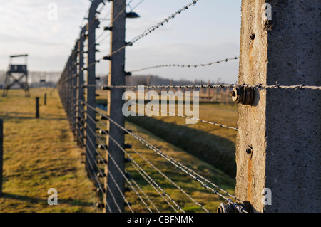 Watchtower beside electrified barbed wire security fence at Auschwitz Berkenau Nazi concentration camp Stock Photo