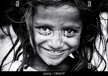Happy young poor lower caste Indian street girl smiling. Black and White Stock Photo