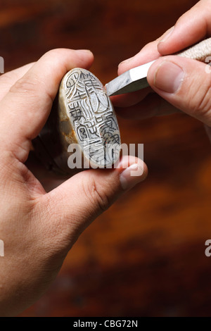 Craftsman carving Chinese character into a Chinese chop Stock Photo - Alamy