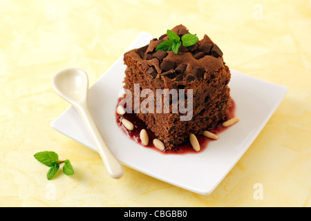 Brownie with cherry jam and pine nuts. Recipe available. Stock Photo