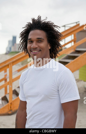 A happy young man at the beach, waist up Stock Photo
