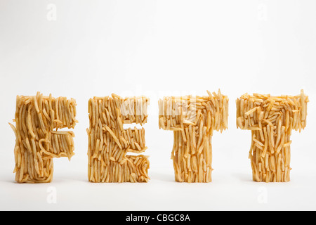 French fries molded to make the word FETT, the German word for fat Stock Photo