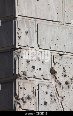 Bullet holes over facade of old building Stock Photo